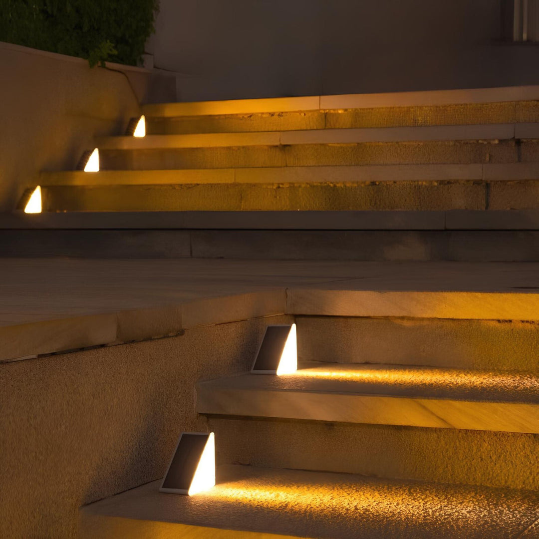 Warm white LED glow from solar stair light, creating inviting ambiance for outdoor living spaces.
