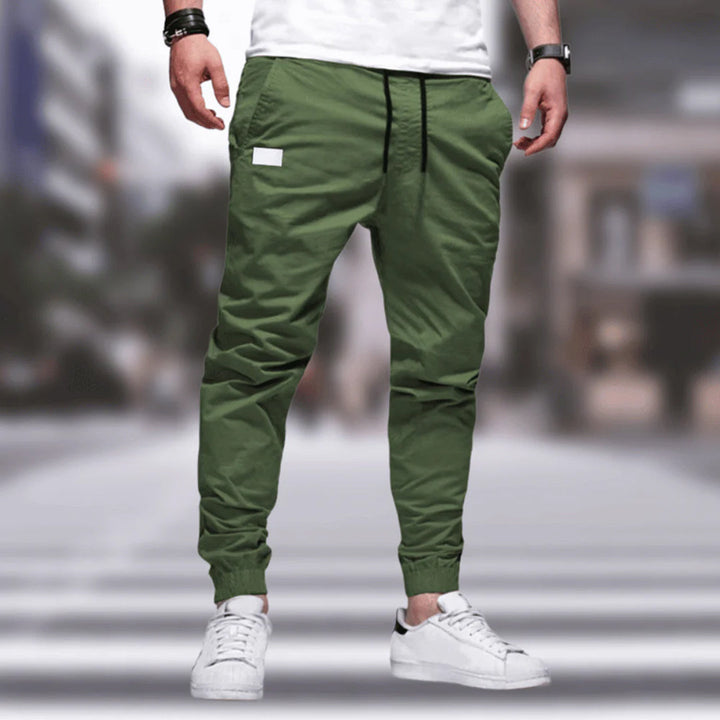 Durable men's cargo pants, relaxed fit, with many practical utility pockets for active use.