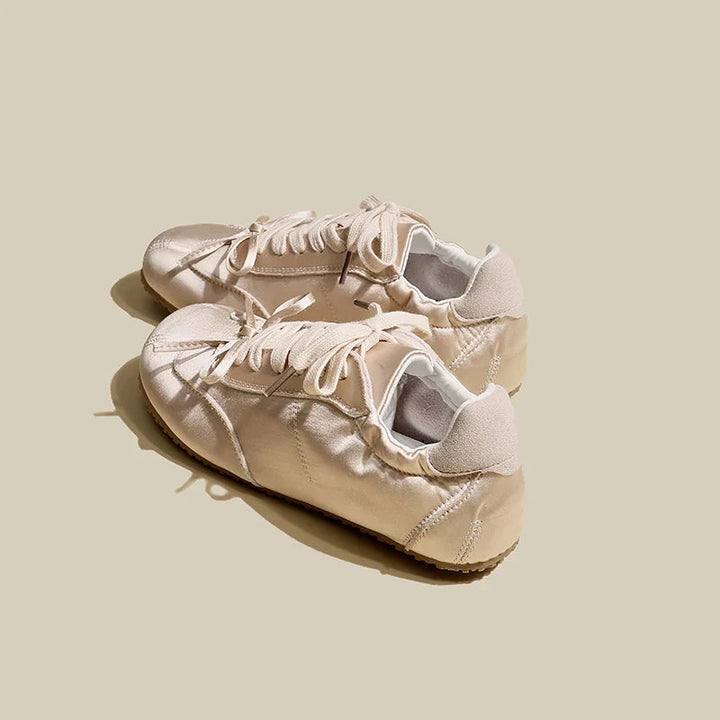 Chic women's low-profile lace-up sneakers offering versatile style and all-day comfort.