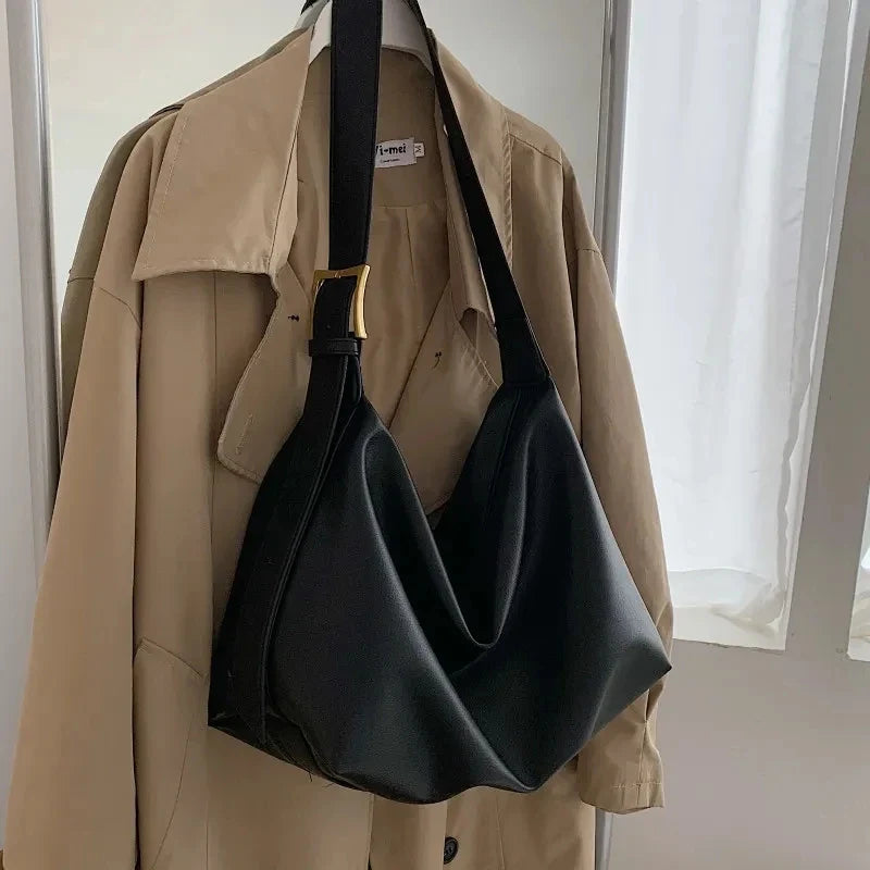 Modern slouchy design women's shoulder tote bag, fashionable faux leather handbag accessory.