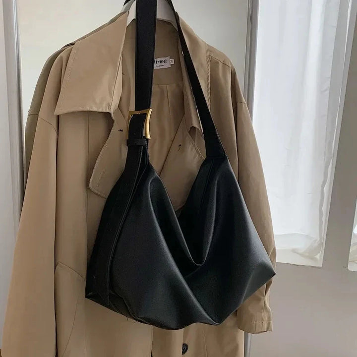 Modern slouchy design women's shoulder tote bag, fashionable faux leather handbag accessory.