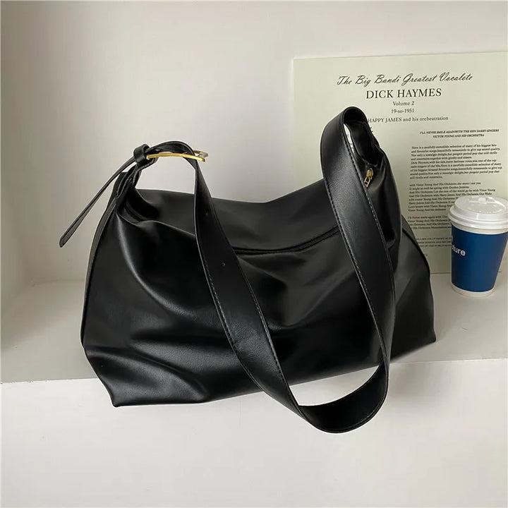 Chic women's slouchy shoulder tote, a versatile faux leather handbag for fashion-forward looks.