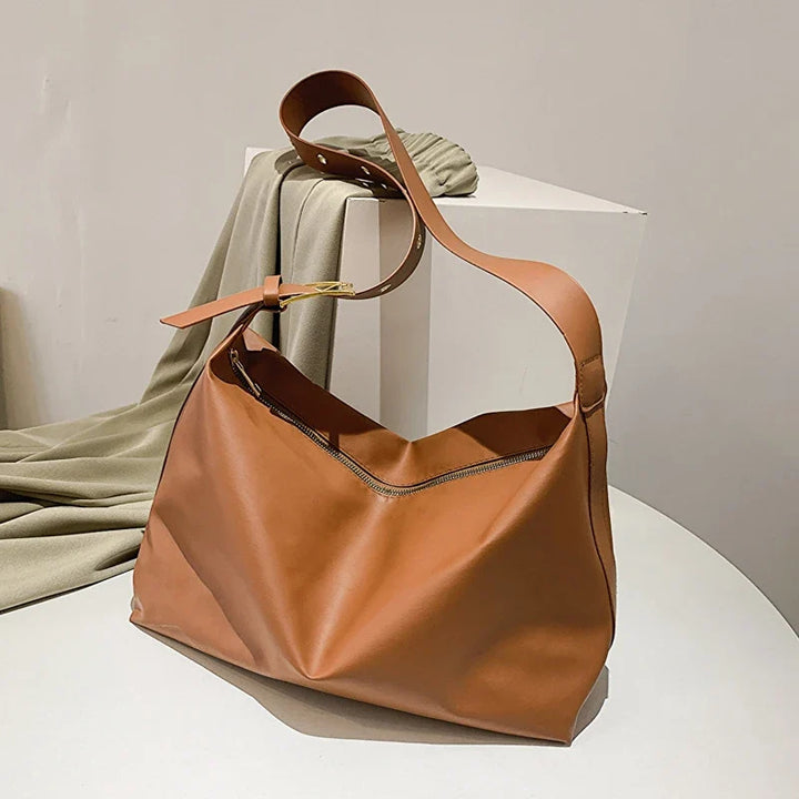 Essential women's slouchy shoulder tote bag, a fashionable faux leather accessory handbag.