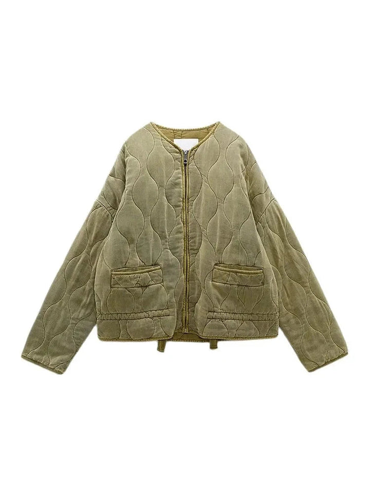 Close-up of a women's quilted jacket, showcasing its unique retro pattern and warm autumn fabric.