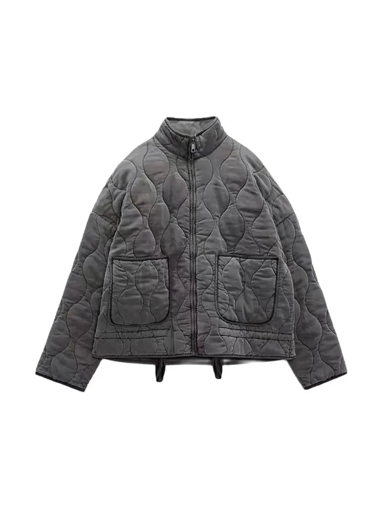 Woman wearing a casual vintage quilted jacket, styled for chic autumn fashion and comfortable fall outerwear.