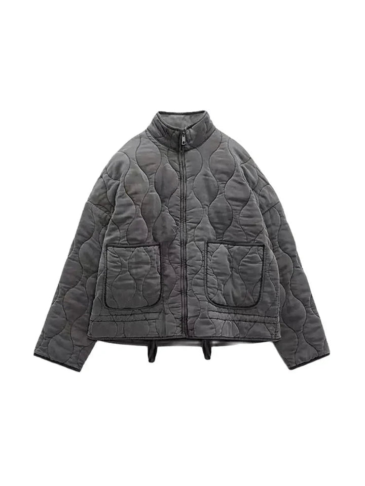 Woman wearing a casual vintage quilted jacket, styled for chic autumn fashion and comfortable fall outerwear.