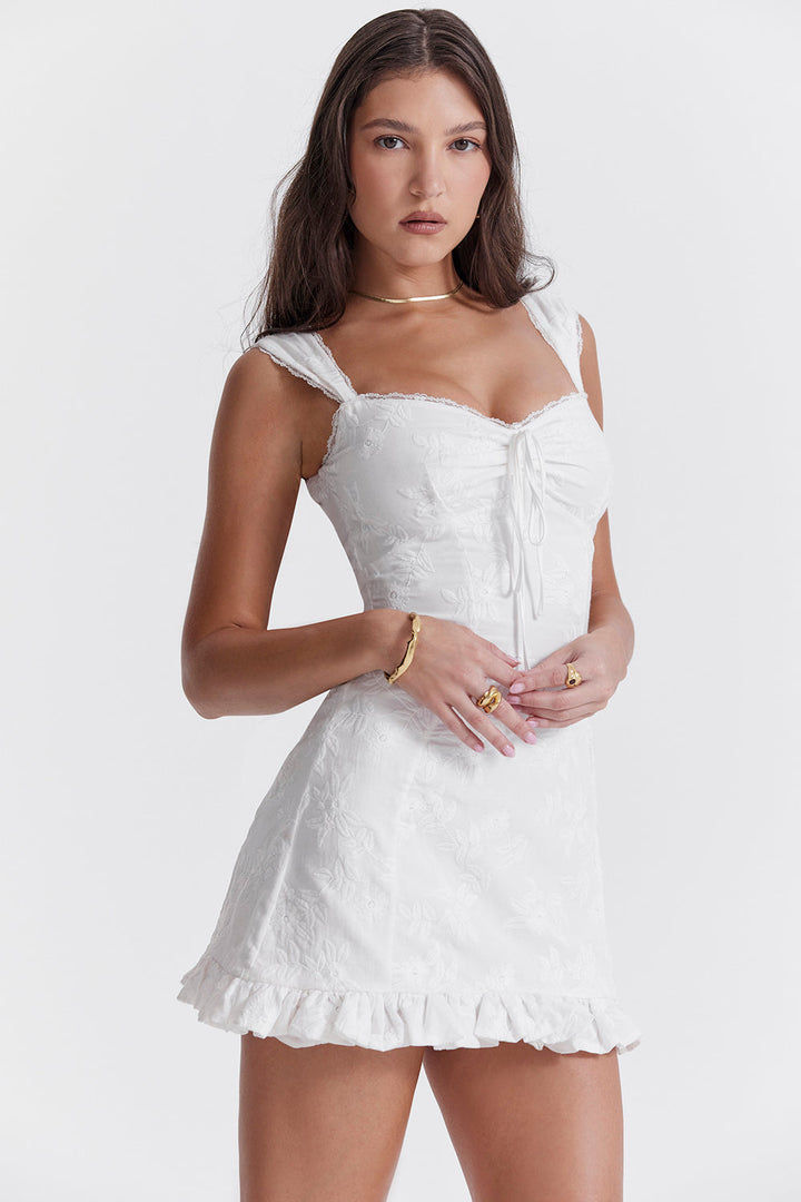Short sleeveless white summer dress for women, designed with a chic tie waist for a flattering fit.