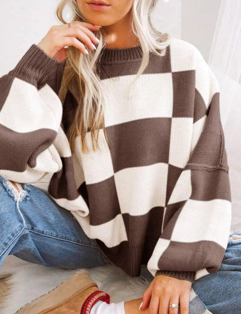 Warm women's knitted jumper, checkerboard design, long sleeve, essential for cold weather.