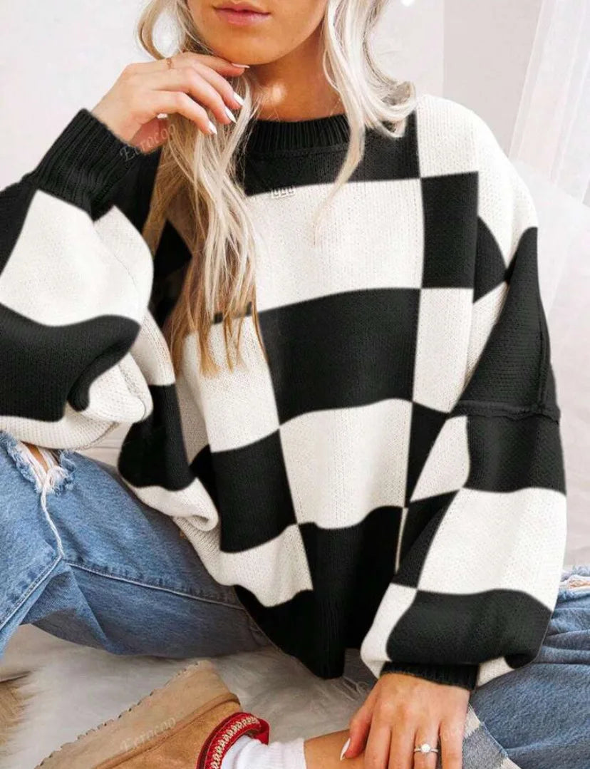 Women's checkerboard patterned long sleeve top, soft knit and trendy oversized style.
