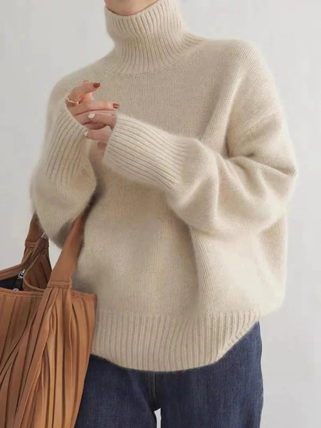 Stylish women's high-neck sweater in beige, offering cozy comfort & chic winter style. Everyday wear.