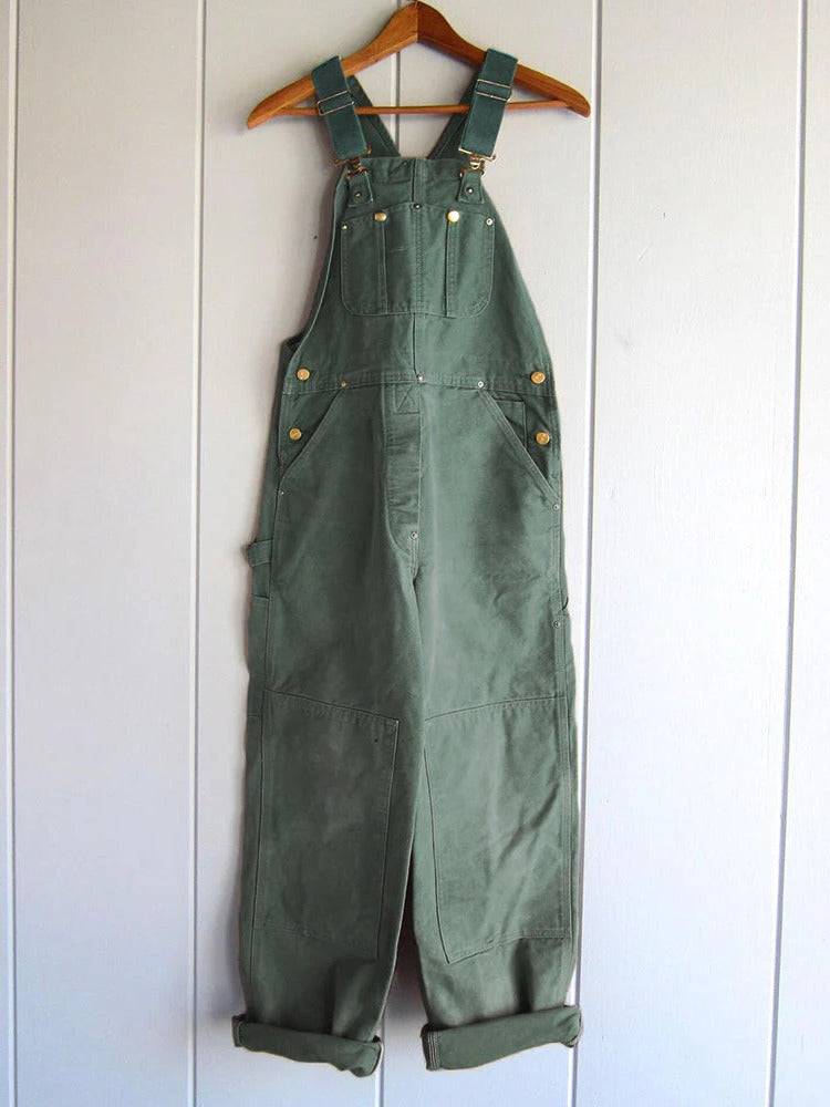 Camel wide leg workwear overalls for women featuring adjustable straps & side pockets.