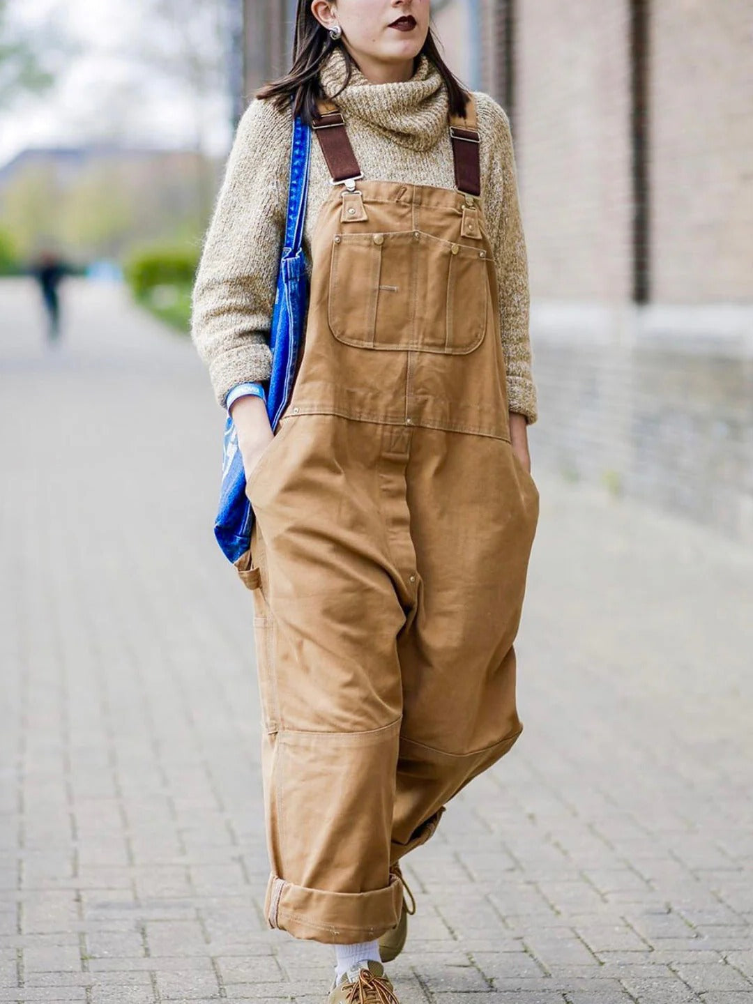 Full shot of women's wide leg overalls in camel, showing adjustable straps & deep side pockets.