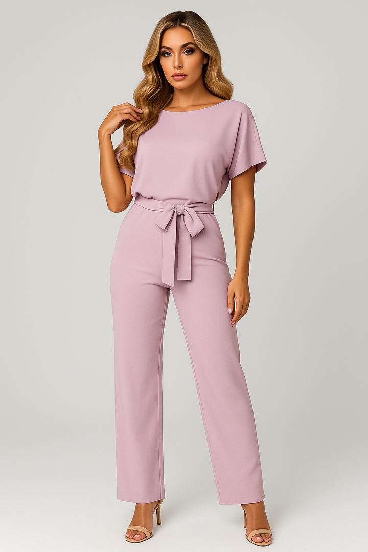 Model wearing a versatile women's wide-leg jumpsuit, showcasing the flattering belted waist and effortless style.