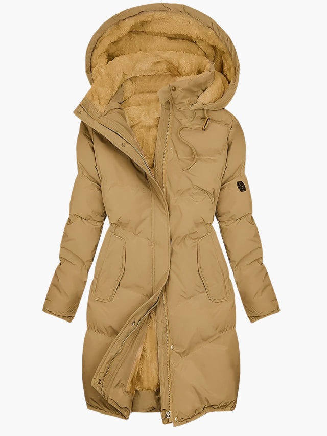 Chic women's long quilted winter coat, featuring a protective hood. A stylish and warm outerwear choice.