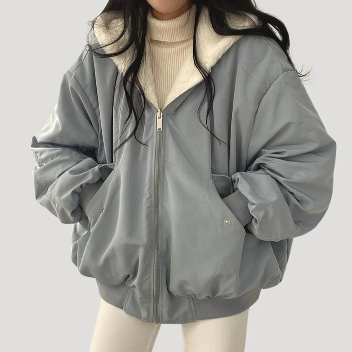 Chic women's oversized long winter jacket with a comfortable hood and button details, versatile for any cold day.