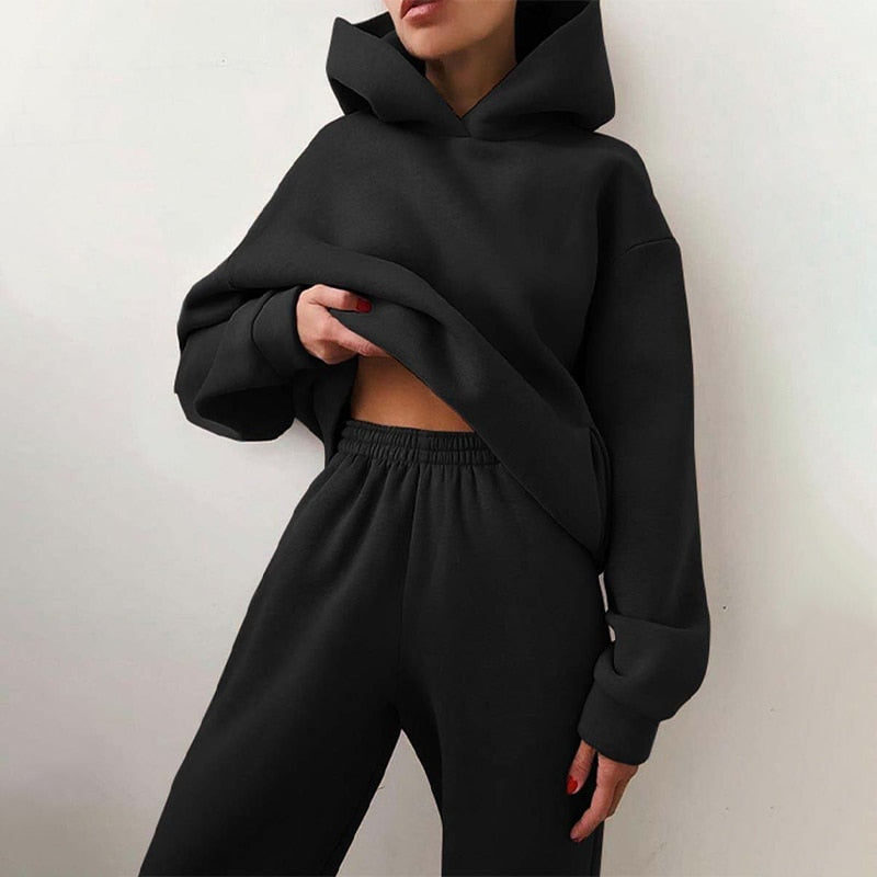 Cozy women's loungewear set; a relaxed fit hoodie and soft cuffed sweatpants perfect for home comfort.