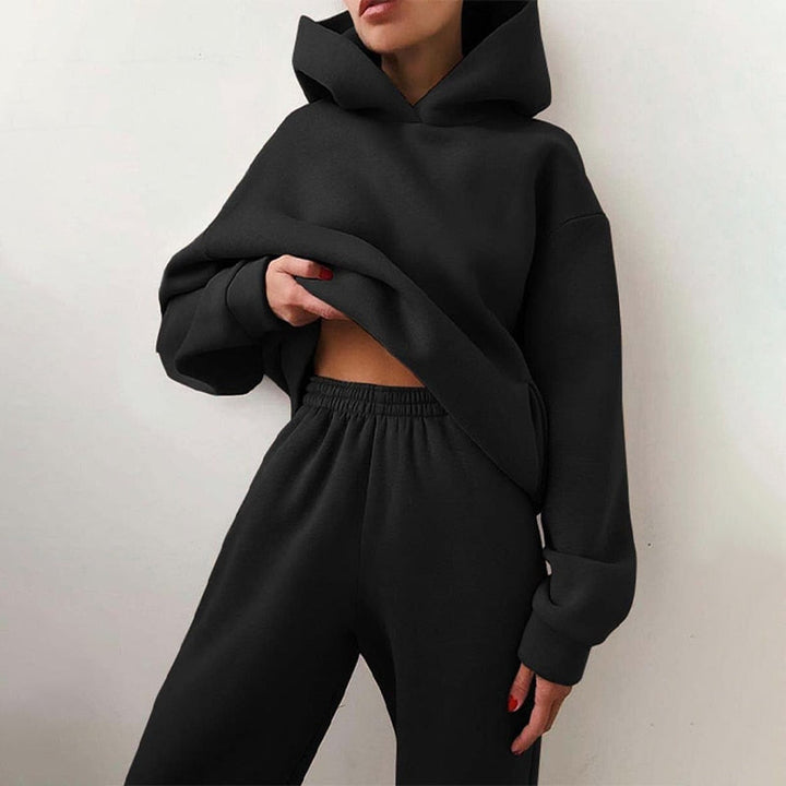 Cozy women's loungewear set; a relaxed fit hoodie and soft cuffed sweatpants perfect for home comfort.