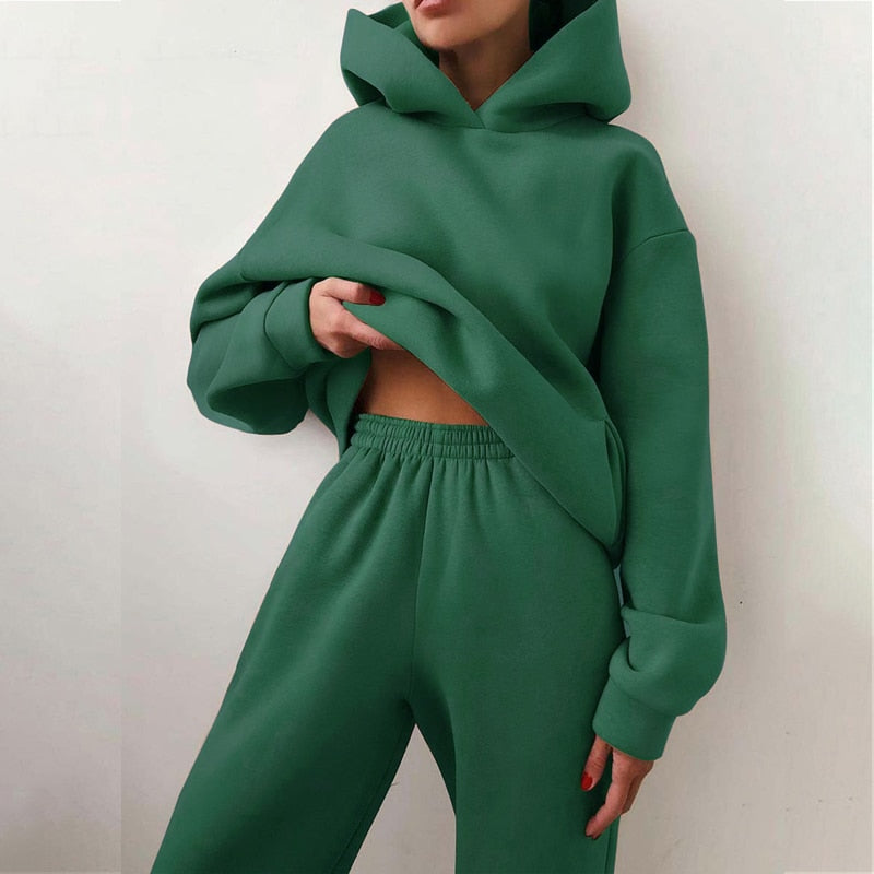 Woman wearing a relaxed fit loungewear set: a cozy hoodie & soft sweatpants, perfect for home or casual errands.