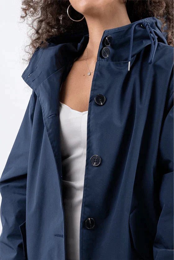 Durable women's waterproof rain jacket, lightweight casual outerwear with an adjustable hood for all-weather protection.