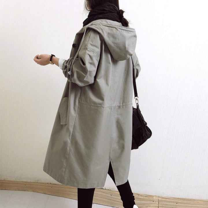 Women's waterproof rain jacket with hood, essential protective outerwear for unpredictable weather & city adventures.