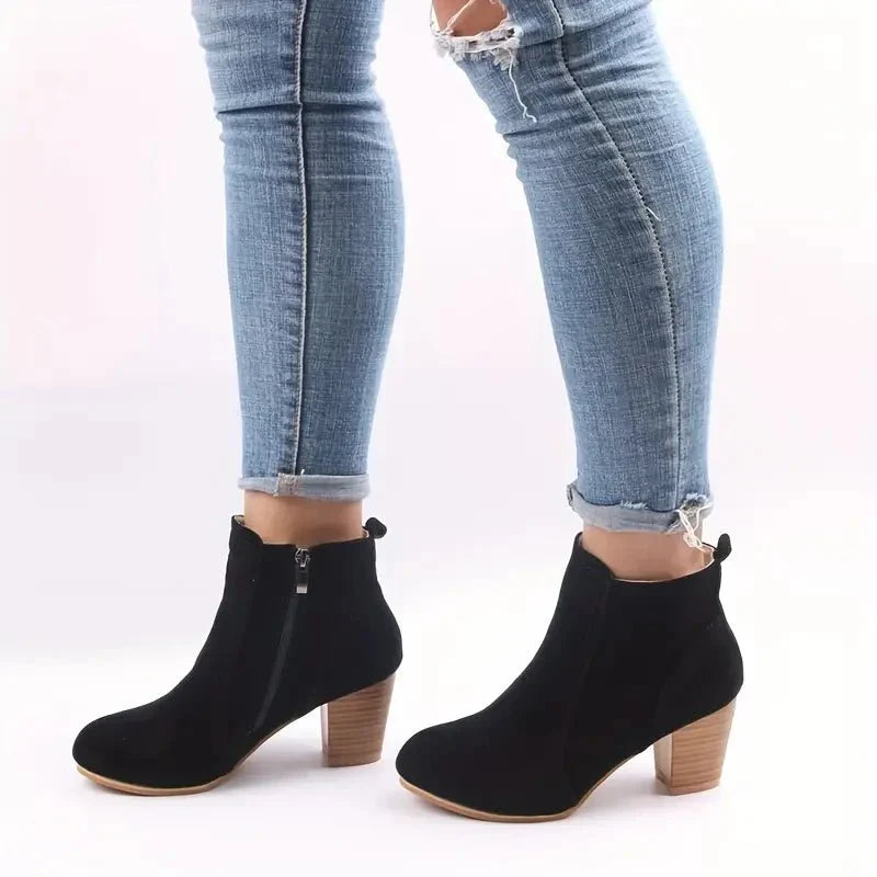 Elegant women's dress ankle boots with a secure side zip and contemporary block heel design.