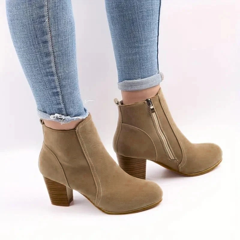 Chic women's black ankle boots with a sturdy block heel and practical side zip, perfect for fall fashion.