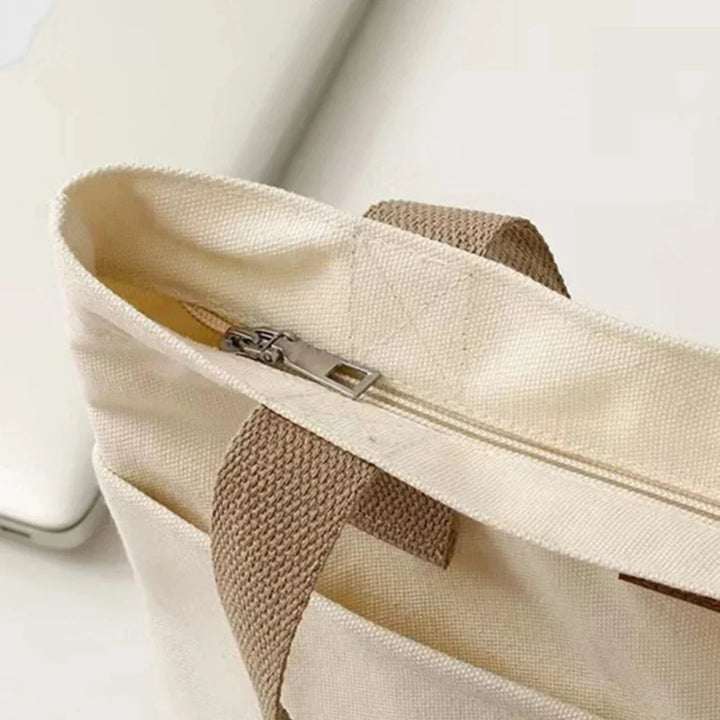 Casual women's canvas beach tote bag, featuring practical front pockets for easy access, great for summer adventures.