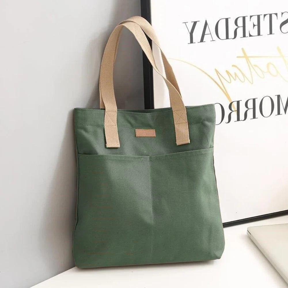 Durable canvas beach tote for women, designed with multiple front pockets to keep your everyday essentials organized.
