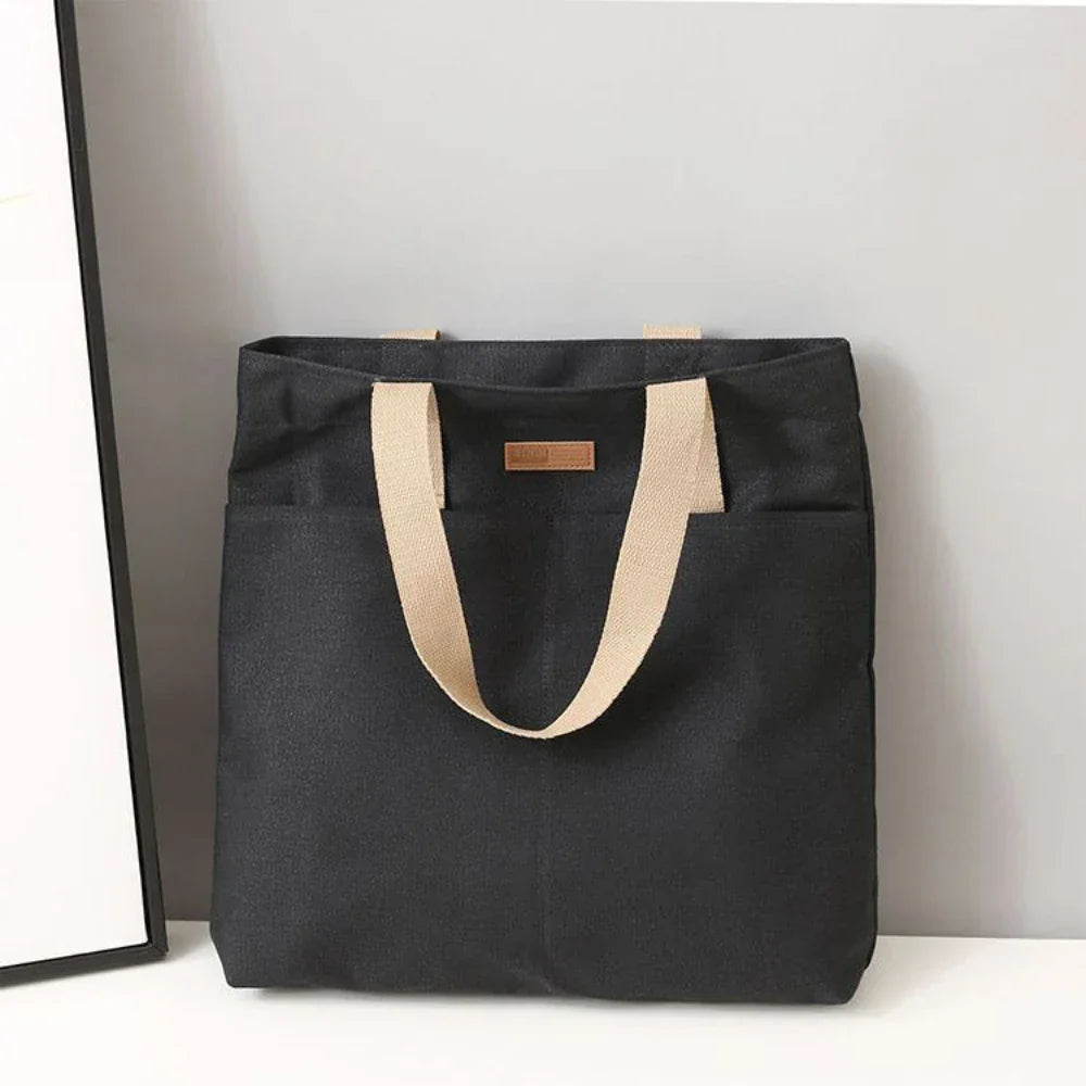 Comfortable women's canvas shoulder tote bag, a perfect beach or everyday carry-all with convenient front pockets.