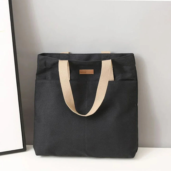 Comfortable women's canvas shoulder tote bag, a perfect beach or everyday carry-all with convenient front pockets.