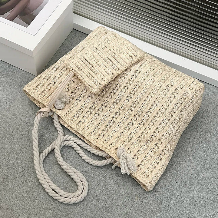 Elegant women's beach tote featuring natural rope handles and a charming woven design, great for coastal adventures.