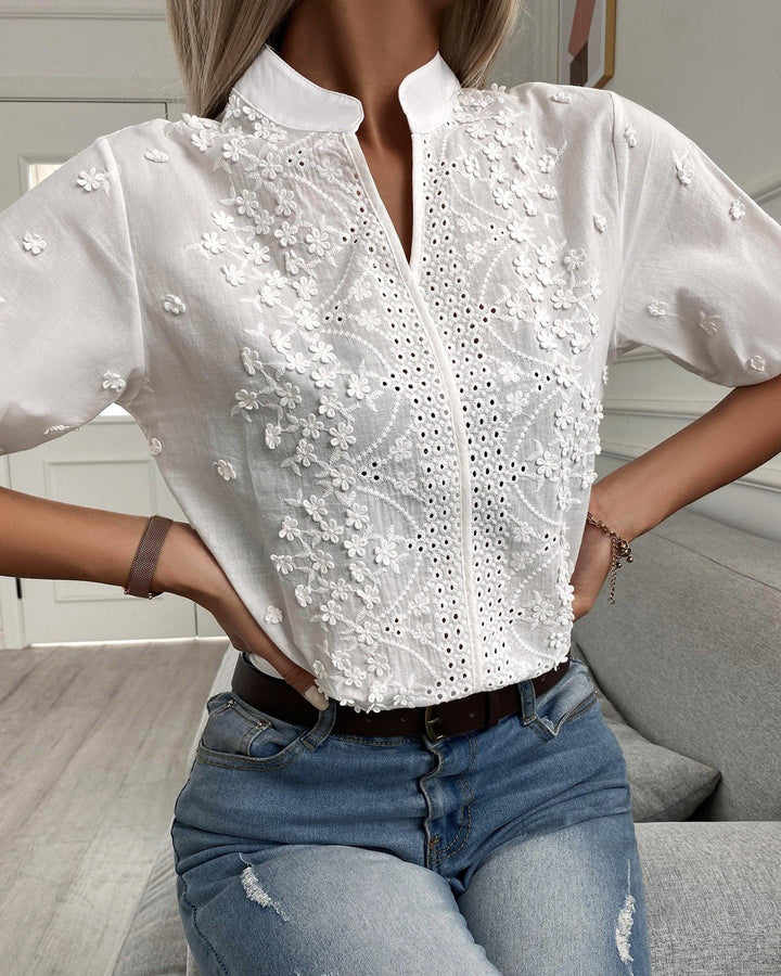 Chic women's floral embroidered V-neck blouse, short puff sleeves, ideal for versatile summer fashion & feminine apparel.