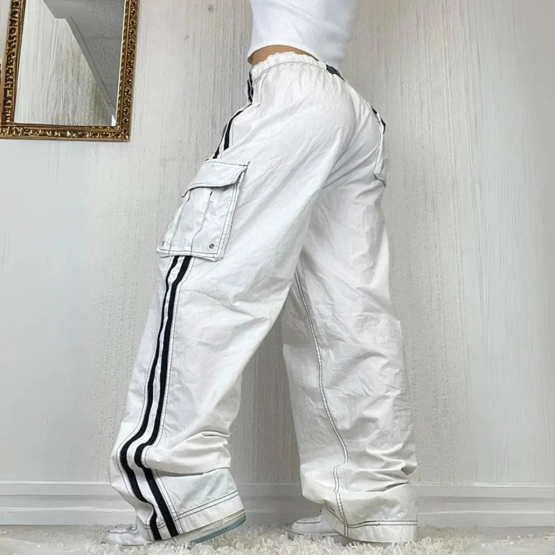 Trendy women's baggy wide leg cargo pants with a sporty side stripe and functional pockets for street fashion.