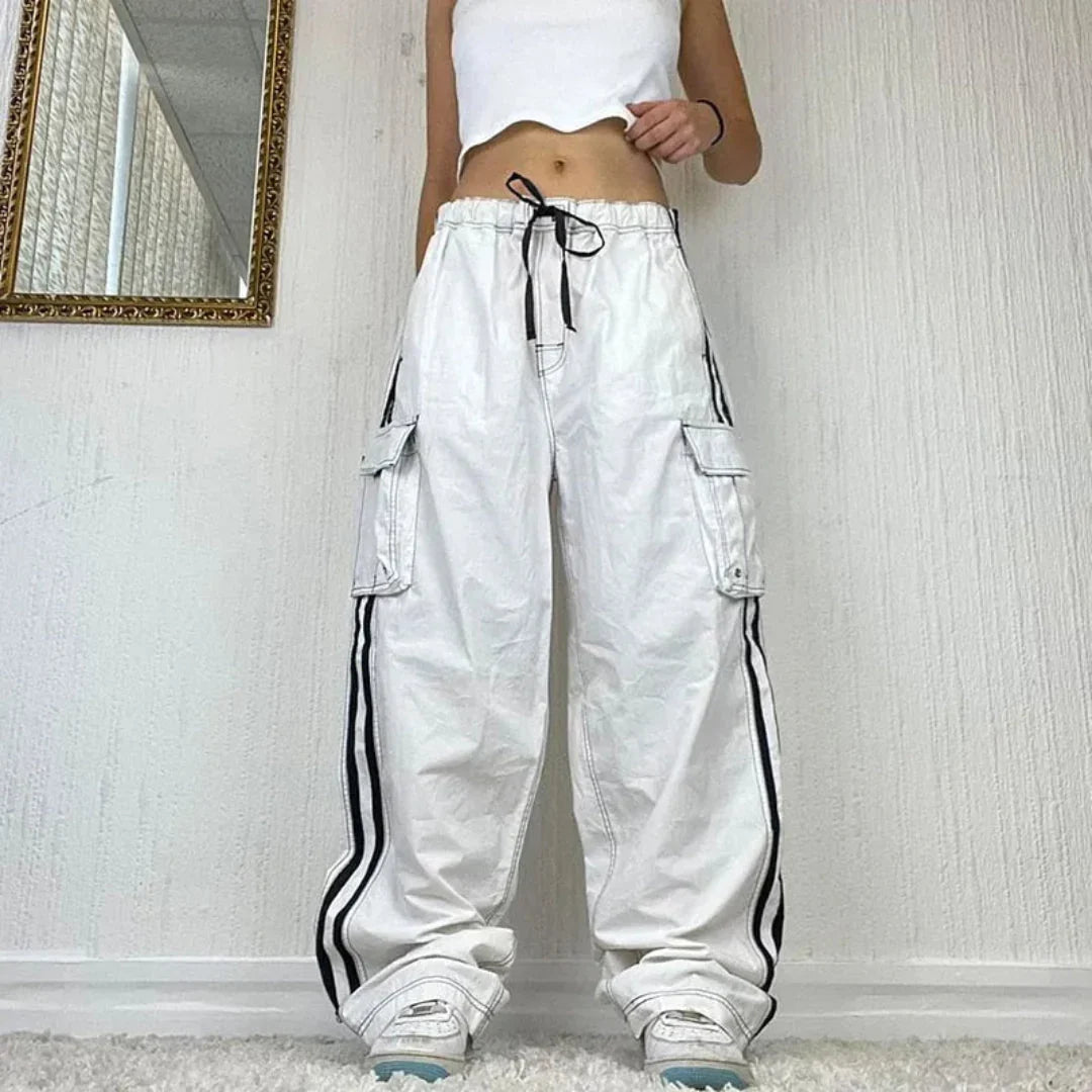 Women's baggy wide leg cargo pants with stylish side stripe and multiple utility pockets. Perfect for street style.