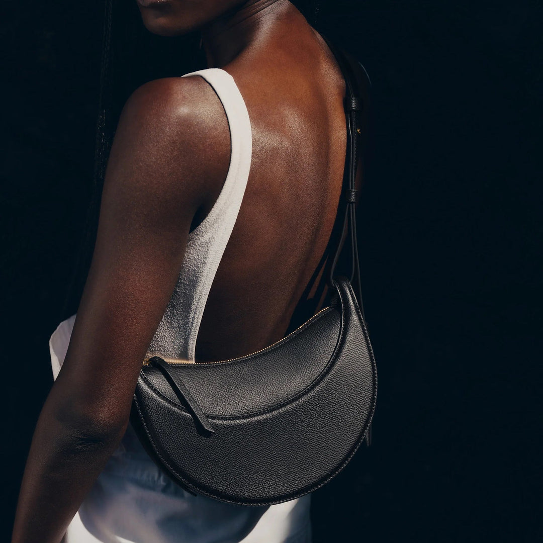 Women's crescent crossbody bag with adjustable strap & zip closure, perfect for everyday style.