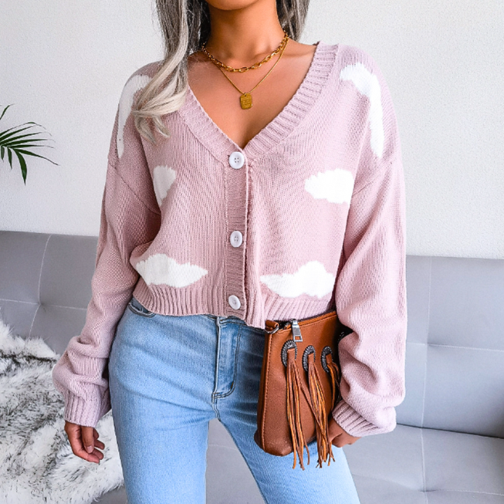 Layer this women's cropped cardigan with cloud print. Features V-neck, button-up closure; perfect for spring outfits.