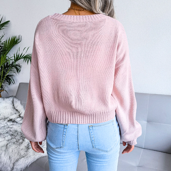 Trendy women's cropped cloud print cardigan. V-neck, button-up, a whimsical addition to women's fashion.