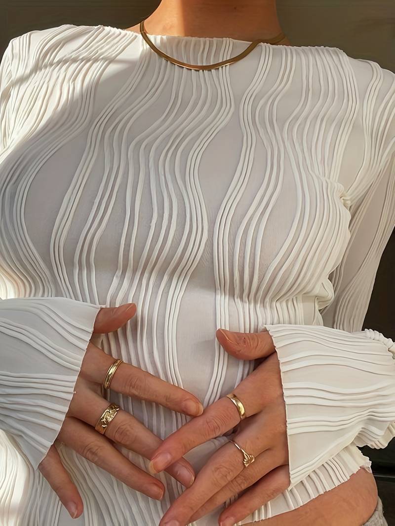 Soft, textured women's cropped long sleeve top with chic wave pattern and comfortable puff cuffs. Fashionable & versatile.