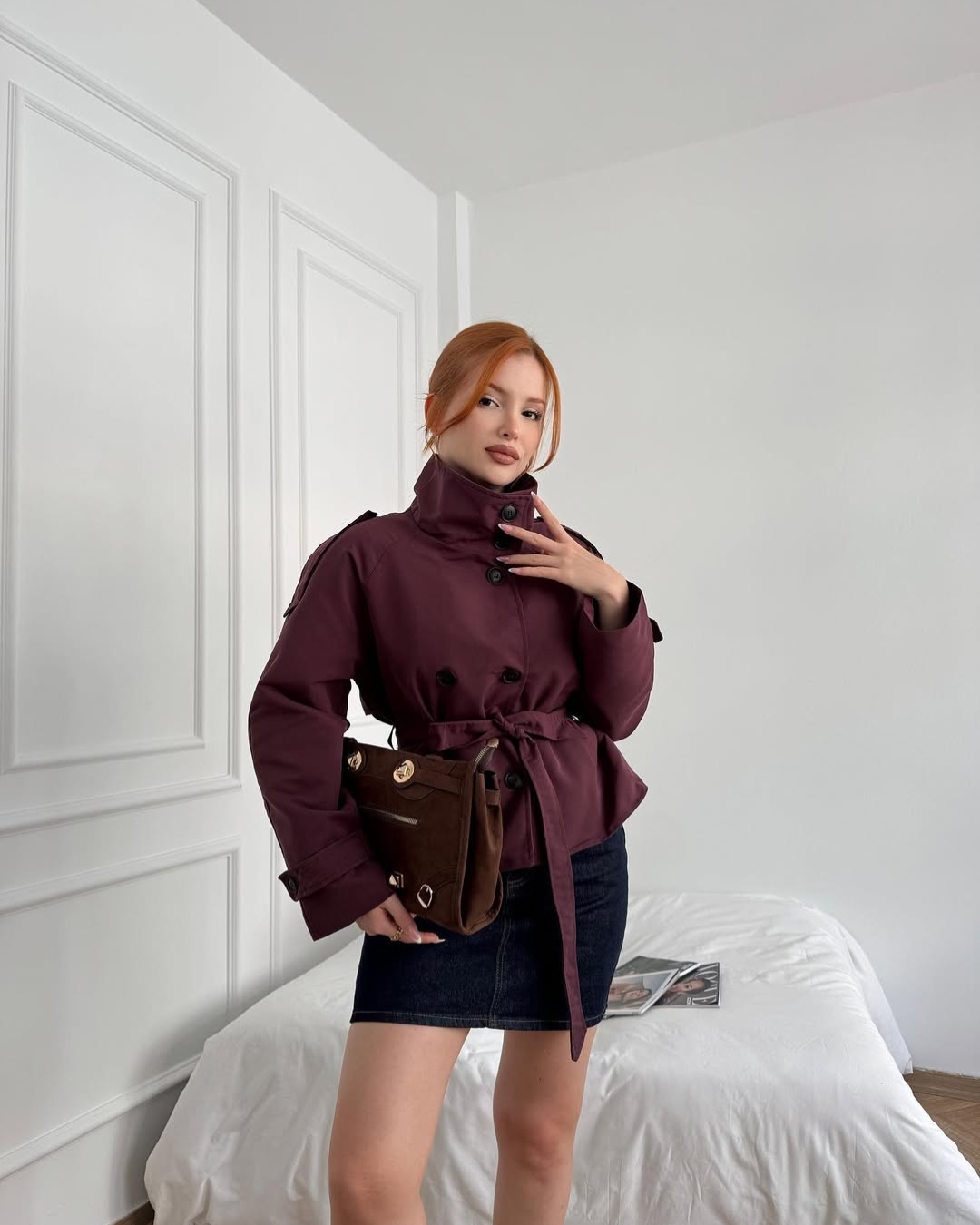 Elegant women's double-breasted cropped trench coat with belt, a stylish outerwear choice.