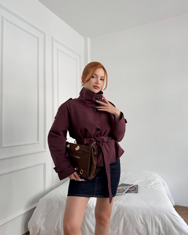 Elegant women's double-breasted cropped trench coat with belt, a stylish outerwear choice.