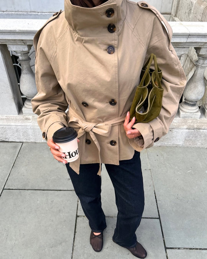Stylish double-breasted cropped trench coat for women, featuring a flattering belted waist.