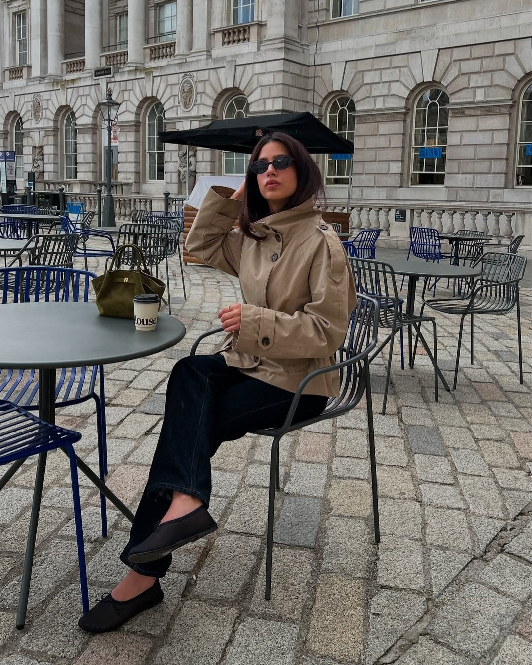 Classic women's double-breasted cropped trench coat, belted for an elegant silhouette.