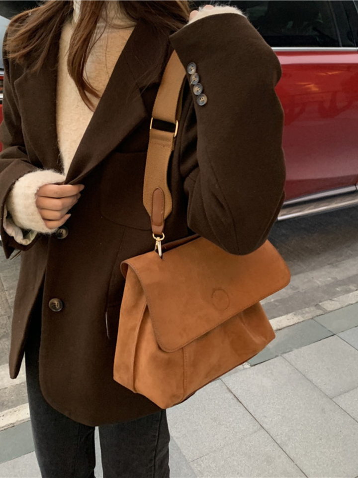 Versatile women's brown crossbody satchel bag, everyday essential with an adjustable shoulder strap.