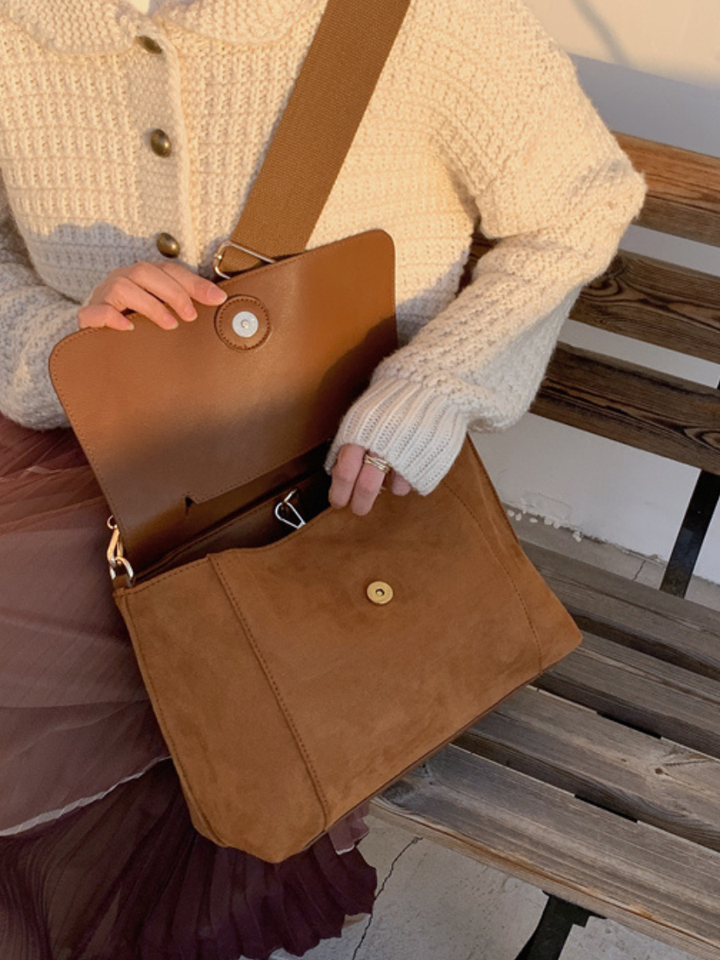 Practical brown women's everyday crossbody bag, designed with an adjustable strap for comfort.