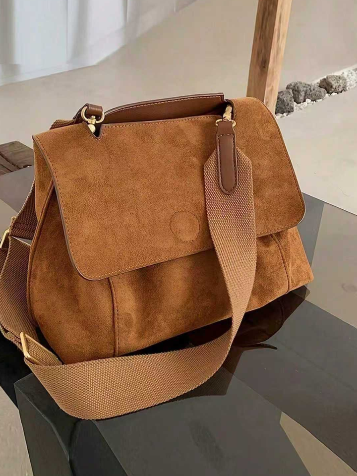 Brown women's everyday shoulder bag, easily converts to crossbody with its adjustable strap.