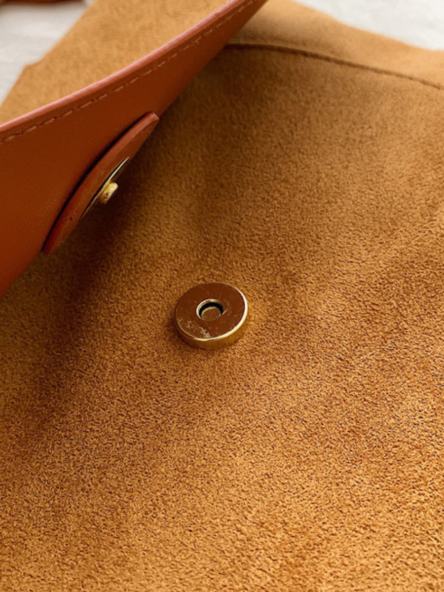 Compact brown women's crossbody bag, ideal for everyday carry, comes with an adjustable strap.