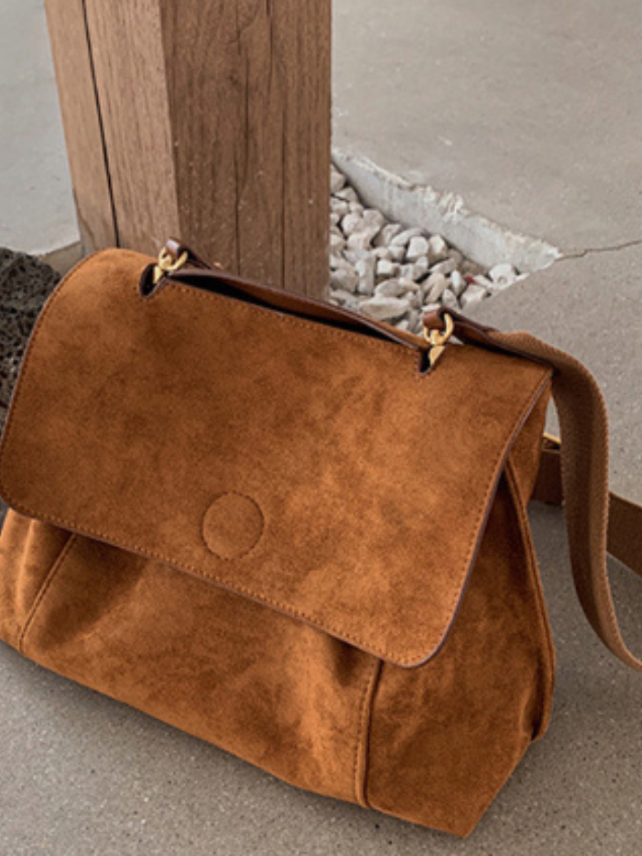 Chic brown women's satchel bag, perfect as an everyday crossbody or shoulder bag, adjustable strap.