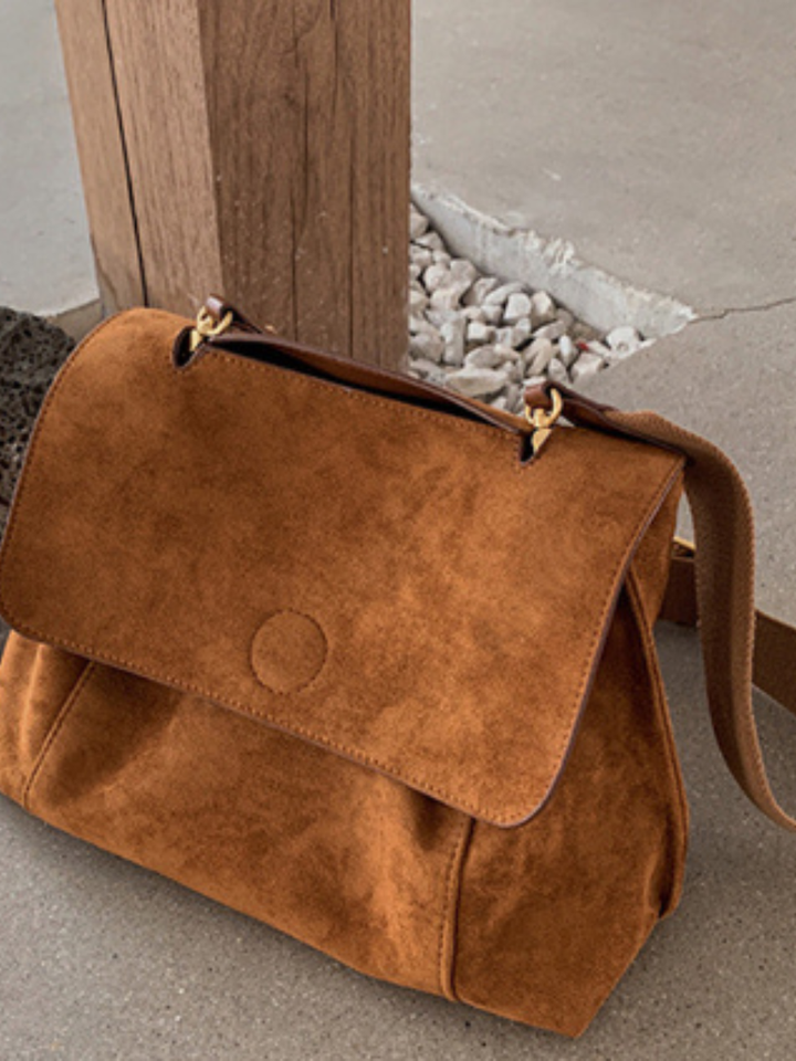 Chic brown women's satchel bag, perfect as an everyday crossbody or shoulder bag, adjustable strap.