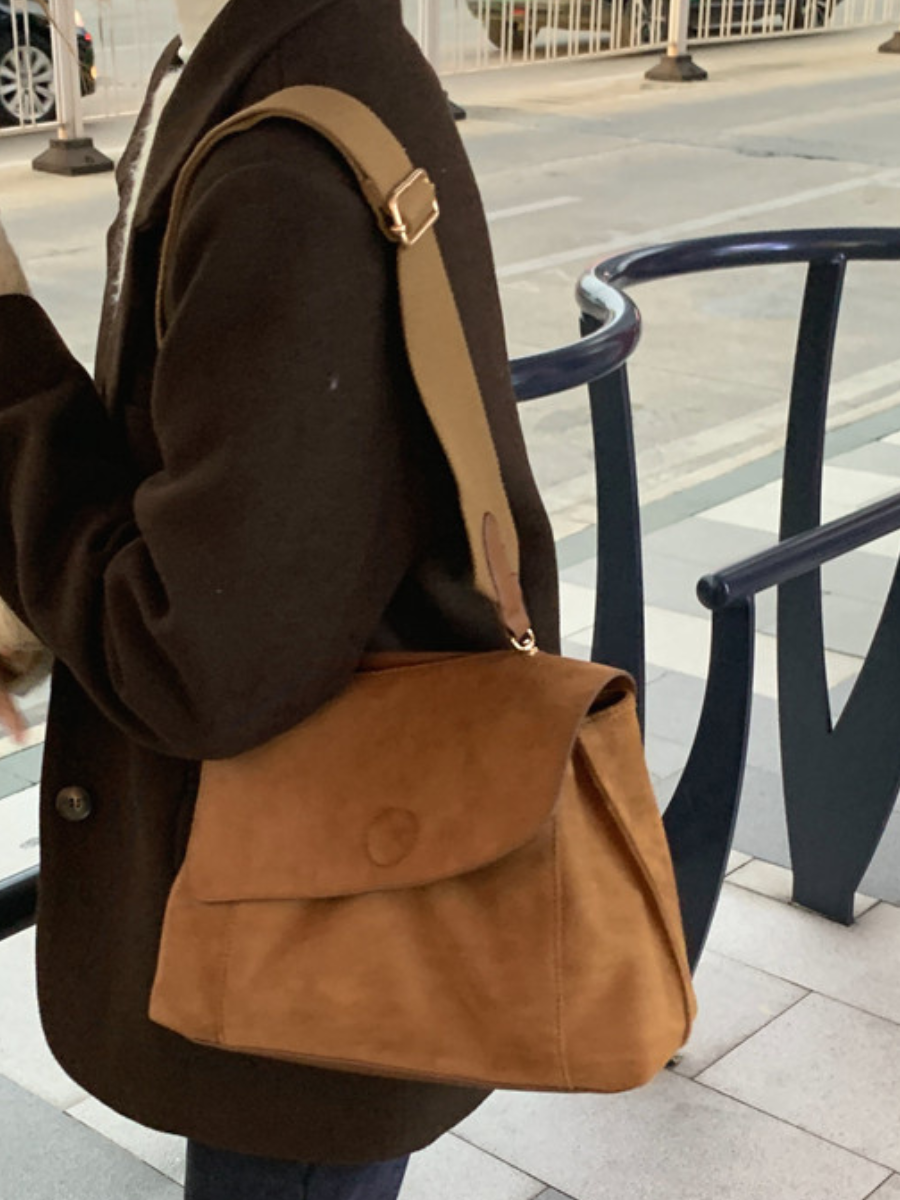 Women's brown everyday crossbody bag with adjustable strap for versatile styling.