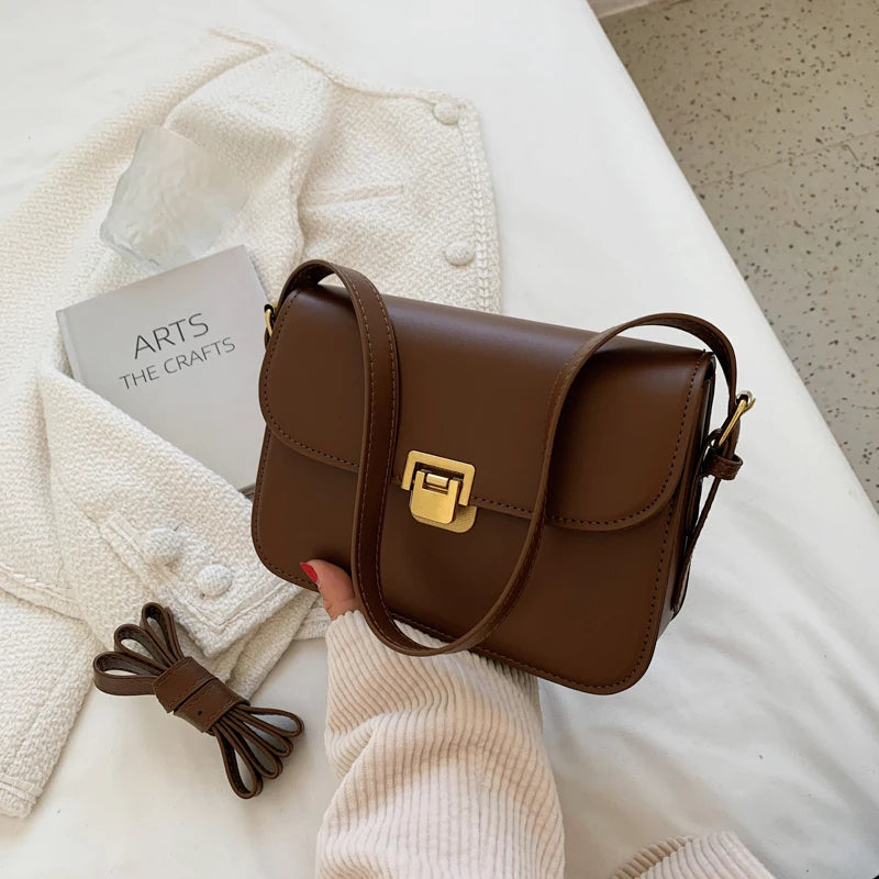 Fashionable women's everyday small flap bag with a distinctive turn-lock, great for convenience.